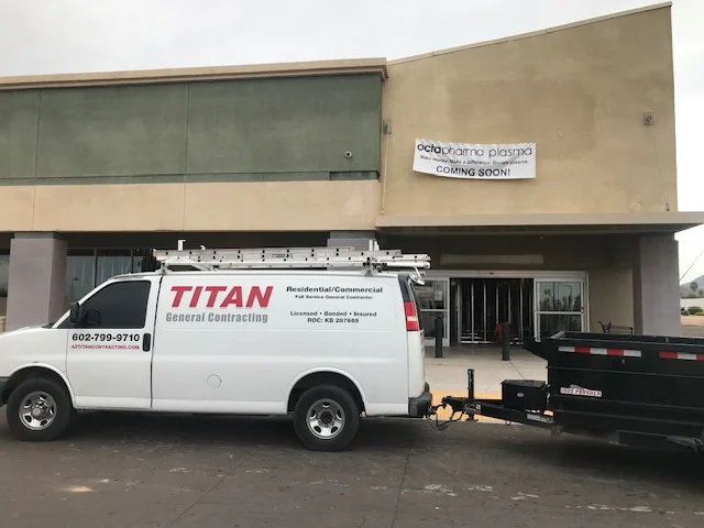 Commercial storefront with new stucco cladding, glass storefront, and updated signage