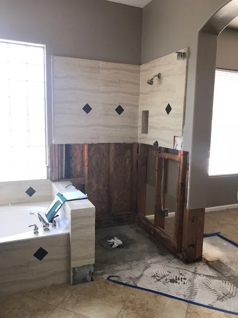 Master bathroom remodel with frameless glass shower, marble and wood-look tile, soaking tub, and diamond accents